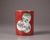 A Chinese coral-red ground famille rose brush pot