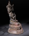 A SINO-TIBETAN BRONZE FIGURE OF THREE-HEADED SEATED BODHISATTVA