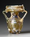 AN INTACT ROMAN OLIVE YELLOW GLASS TWIN-HANDLED JAR, CIRCA 4TH CENTURY A.D.