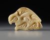 A WESTERN ASIATIC MARBLE SEAL AMULET IN THE FORM OF A BIRD OF PREY, LATE URUK PERIOD, CIRCA 3300-2900 B.C.