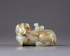 A CHINESE CELADON AND RUSSET JADE BUDDHIST LION WATER DROPPER, CHINA, QING DYNASTY (1644-1911)