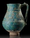 A TURQUOISE GLAZED POTTERY EWER, PROBABLY NISHAPUR, 12TH CENTURY