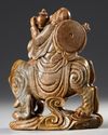 A CHINESE SOAPSTONE CARVED LUOHAN RIDING AN ELEPHANT, 19TH CENTURY