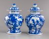 A pair of blue and white Chinese 'cherry blossom' vases and covers