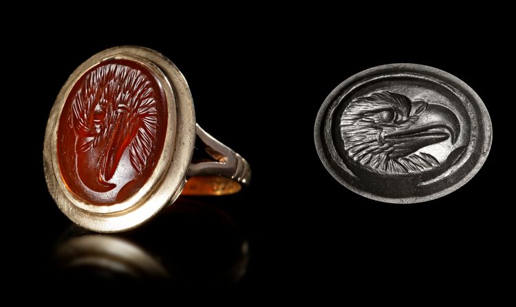 A CARNELIAN ROMAN INTAGLIO OF AN EAGLE'S HEAD, 1ST CENTURY AD