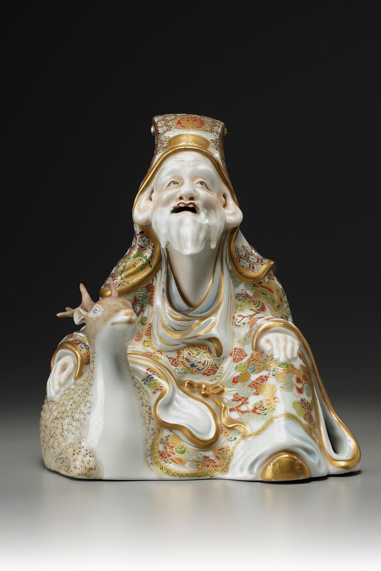 A JAPANESE SATSUMA FIGURE OF SEATED JUROJIN AND A DEER, MEIJI PERIOD (1868-1912)