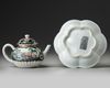 A CHINESE BLACK-GROUND FAMILLE ROSE TEAPOT, COVER AND STAND, YONGZHENG PERIOD (1723-1735)