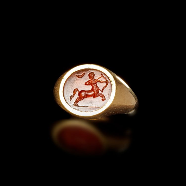 ROMAN GOLD RING WITH ORANGE INTAGLIO OF A HUNTING CENTAUR 1ST–2ND CENTURY A.D.