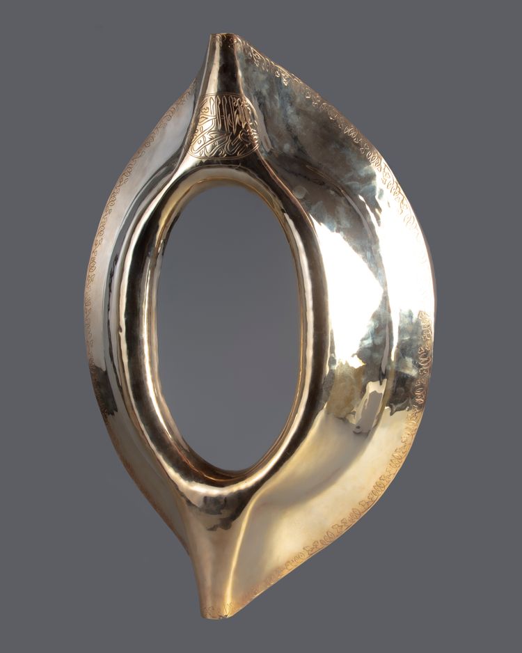 An Ottoman gilt metal frame of the black stone AL-hajaru al Aswad