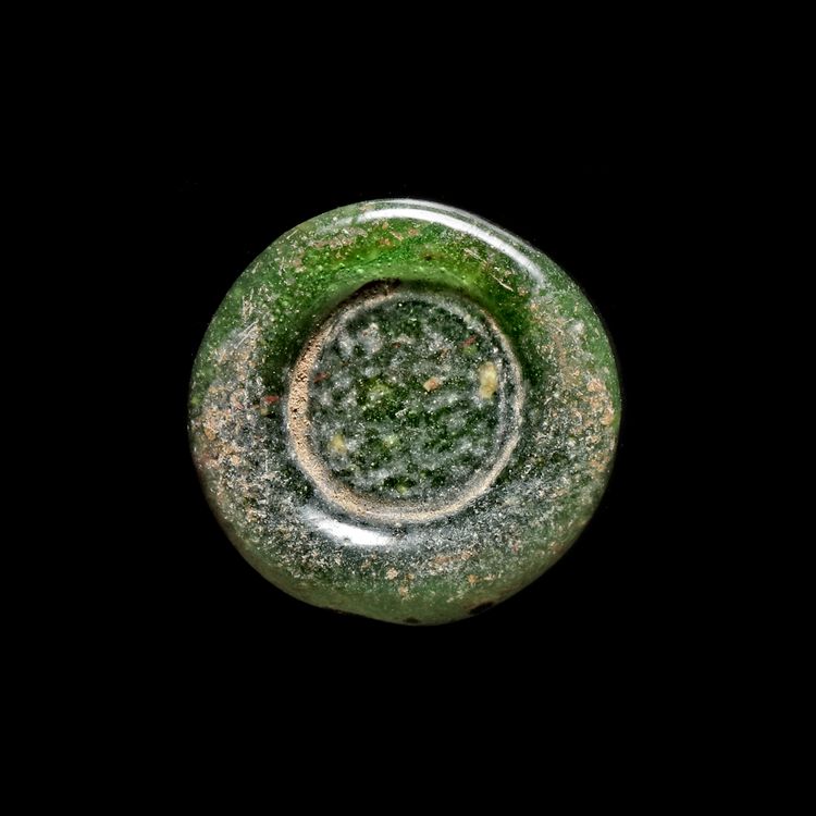 A FATIMID GLASS WEIGHT OF DOUBLE DIRHAM, AL-HAKIM BI-AMR ALLAH (386AH-411AH/ 996AD-1021AD)