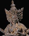 A SINO-TIBETAN BRONZE FIGURE OF THREE-HEADED SEATED BODHISATTVA