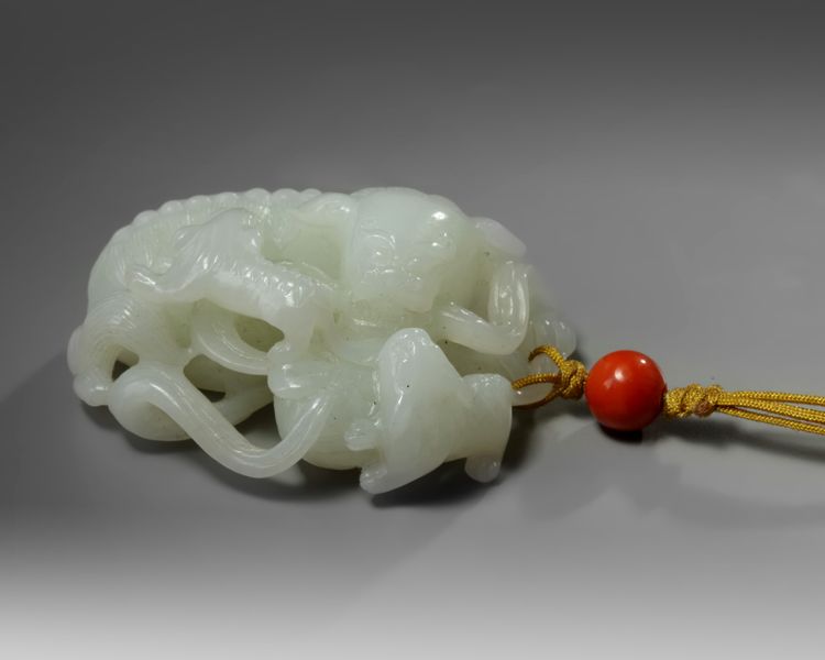 A Chinese white jade 'Buddhist lion and cubs' carving