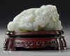 A CHINESE CELADON JADE CARVING OF A WATER BUFFALO GROUP, 19TH-20TH CENTURY