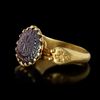 A BYZANTINE GOLD RING SET WITH A GARNET INTAGLIO, 6TH CENTURY AD OR LATER