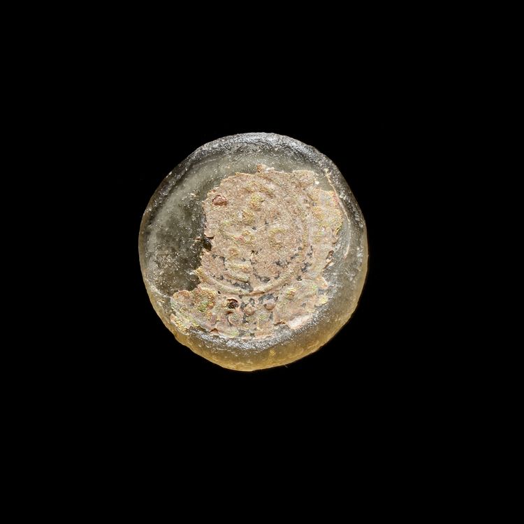 A FATIMID GLASS WEIGHT THREE QUARTER DINAR, AL-HAKIM BI-AMR ALLAH (386AH-411AH/ 996AD-1021AD)