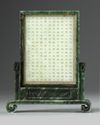A Chinese pale celadon jade plaque in a spinach green jade stand