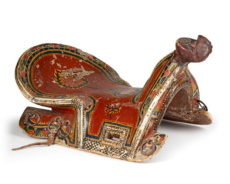 A POLYCHROME-PAINTED AND LACQUERED WOODEN SADDLE, CENTRAL ASIA, LATE 19TH CENTURY