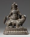 A CHINESE BRONZE FIGURE OF JAMBHALA ON A BUDDHIST LION, CHINA, 19TH-20TH CENTURY