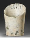 A RARE ALTERED OPAQUE BUFF JADE HOOF-SHAPED TUBULAR ORNAMENT, CHINA