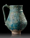A TURQUOISE GLAZED POTTERY EWER, PROBABLY NISHAPUR, 12TH CENTURY