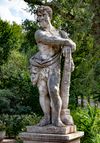 A SCULPTED LIMESTONE MODEL OF HERCULES, FIRST QUARTER 20TH CENTURY
