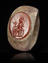 A ROMAN BRONZE RING WITH CARNELIAN INTAGLIO, CIRCA 2ND-3RD CENTURY A.D.