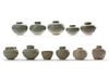 NINE SMALL CHINESE CELADON JARS AND A CUP, 13TH-14TH CENTURY