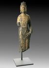 A FINELY CARVED STONE FIGURE OF A STANDING BUDDHIST DEITY