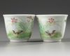 A pair of Chinese famille rose 'bird and lily' cups