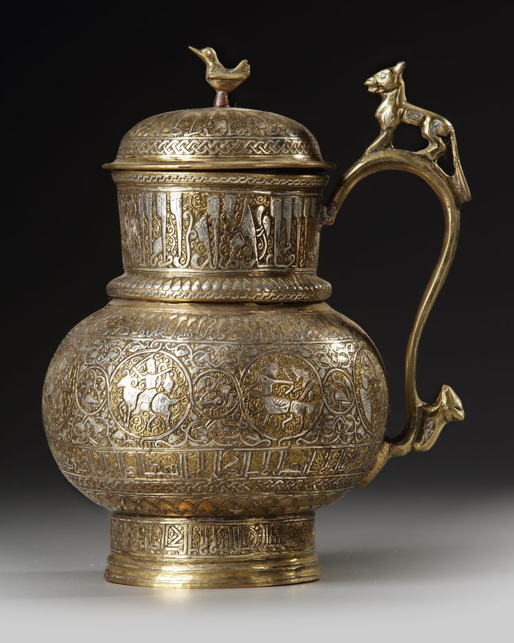 A PERSIAN SILVER INLAID COVERED BRONZE JUG, KHURASAN STYLE, 19TH CENTURY