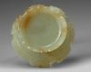 A CHINESE PALE AND RUSSET CARVED JADE 'LOTUS' CENSER