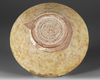 A NISHAPUR SLIP-PAINTED POTTERY BOWL, PERSIA 10TH-11TH CENTURY