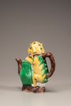 A moulded yellow, green, and aubergine-glazed teapot