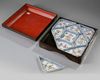 A set of Chinese famille rose 'Immortals' sweetmeat dishes in a lacquered box