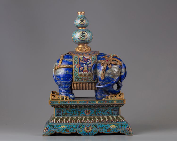 A lapis lazuli carving of a elephant with cloisonné mounts and stand