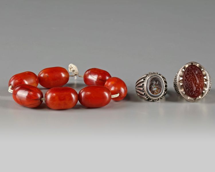 Two silver rings and an amber bracelet