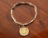 A 14 CARAT GOLD BRACELET WITH A 'SWISS 20 FRANC' GOLD COIN PENDANT