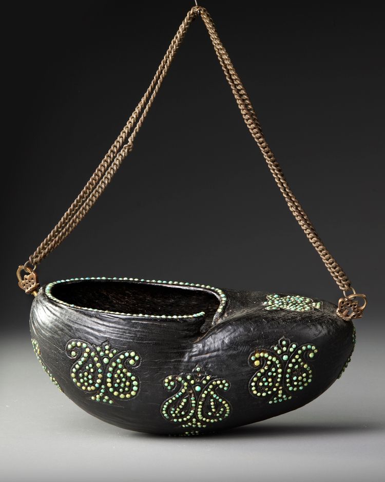 A QAJAR COCO-DE-MER BEGGAR'S BOWL (KASHKUL), PERSIA, 19TH CENTURY