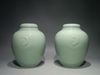 A PAIR OF CHINESE CELADON-GLAZED JARS AND COVERS