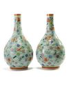 A pair of Chinese famille rose celadon-ground slip-decorated bottle vases