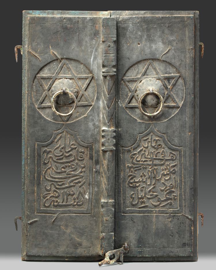 Two carved wooden window shutters