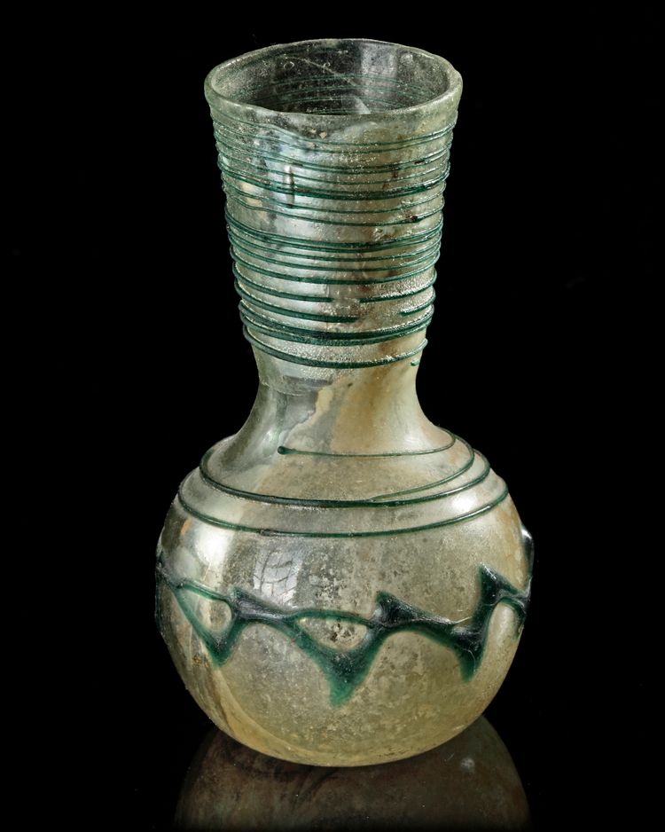 A ROMAN LIGHT GREEN GLASS VASE, 1ST CENTURY AD