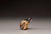 An ivory and laquer Netsuke