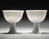 A PAIR OF CHINESE WHITE-GLAZED DRAGONS STEM CUPS, 20TH CENTURY