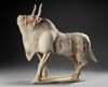 A VERY RARE LARGE OF A WALKING OX IN FULL HARNESS, CHINA, SIX DYNASTIES (220-582 AD)