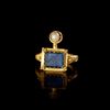 A GOLD RING WITH A BLUE GLASS INLAY, 1ST CENTURY AD OR LATER