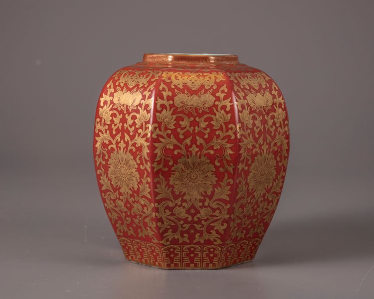 A coral-red ground gilt floral-decorated jar