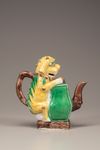 A moulded yellow, green, and aubergine-glazed teapot