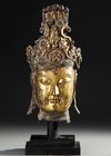 A LARGE GILT BRONZE HEAD OF GUANYIN, MING DYNASTY OR LATER