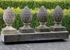 A SET OF FOUR CARVED LIMESTONE PIER FINIALS, 20TH CENTURY